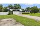 Home exterior showcasing a two-car garage, a well-maintained lawn, and a driveway with ample parking space at 37331 Hickory Hill Ln, Dade City, FL 33525