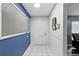 Home interior view featuring a hallway with tiled floors, blue accent wall, and access to other rooms at 37331 Hickory Hill Ln, Dade City, FL 33525
