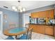 Eat-in kitchen featuring tile floors, a stylish light fixture, and direct access to the kitchen at 37331 Hickory Hill Ln, Dade City, FL 33525