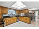Well-lit kitchen with black countertops, wooden cabinetry, and stainless steel appliances at 37331 Hickory Hill Ln, Dade City, FL 33525