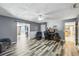 Open living room with laminate floors, ceiling fan, and views of adjacent rooms at 37331 Hickory Hill Ln, Dade City, FL 33525