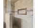 Shower stall with neutral tile surround, a corner shelf, and glass door at 37331 Hickory Hill Ln, Dade City, FL 33525
