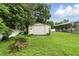 This storage shed provides outdoor storage space for tools and equipment with lawn at 37331 Hickory Hill Ln, Dade City, FL 33525