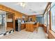Sunroom featuring wood paneling, tile floors, bar and ample natural light at 37331 Hickory Hill Ln, Dade City, FL 33525
