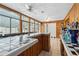 Spacious sunroom featuring wood paneling, tile floors, bar and ample natural light at 37331 Hickory Hill Ln, Dade City, FL 33525