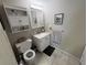 The bathroom has a vanity, sink, toilet, mirror, and lighting at 4137 Lake Bayshore Dr # C505, Bradenton, FL 34205