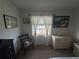 Bedroom with large window and view, dresser, and decorative wall art at 4137 Lake Bayshore Dr # C505, Bradenton, FL 34205