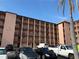 Multi-story condo building featuring balconies, covered parking, and well-maintained exterior against a bright, blue sky at 4137 Lake Bayshore Dr # C505, Bradenton, FL 34205