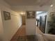 Inviting hallway leads to kitchen with stainless steel refrigerator; tiled floor and neutral walls at 4137 Lake Bayshore Dr # C505, Bradenton, FL 34205