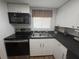 Kitchen featuring stainless steel appliances, white cabinets, and ample counter space at 4137 Lake Bayshore Dr # C505, Bradenton, FL 34205