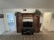 Living room with entertainment center, adjacent to bedroom and hallway entrances at 4137 Lake Bayshore Dr # C505, Bradenton, FL 34205