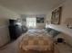 Tastefully decorated main bedroom with calming colors, window and soft natural light at 4137 Lake Bayshore Dr # C505, Bradenton, FL 34205