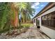 Exterior view of the backyard with palm trees and a stone patio at 4650 87Th N Ter, Pinellas Park, FL 33782