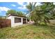 Side view of the backyard with a palm tree and patio at 4650 87Th N Ter, Pinellas Park, FL 33782