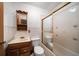 Traditional bathroom with a vanity, toilet, and tub with gold trimmed sliding doors at 4650 87Th N Ter, Pinellas Park, FL 33782