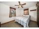 Modest bedroom featuring a ceiling fan, two windows, and a plaid comforter on the bed at 4650 87Th N Ter, Pinellas Park, FL 33782