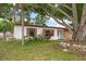 Inviting single-story home with wood-look shutters, mature trees, and partial stone facade at 4650 87Th N Ter, Pinellas Park, FL 33782