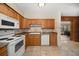 Classic kitchen featuring wood cabinets, a white oven range, and tile flooring at 4650 87Th N Ter, Pinellas Park, FL 33782