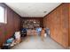 Cluttered storage room with wood paneling and ample shelving at 4650 87Th N Ter, Pinellas Park, FL 33782