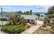 Aerial view of a waterfront home with lush landscaping and a tranquil bay backdrop at 4749 Baywood Point S Dr, Gulfport, FL 33711