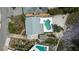 Birds eye view of a waterfront home with a unique shaped pool, driveway, and beautiful bay access at 4749 Baywood Point S Dr, Gulfport, FL 33711
