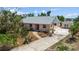 Charming single-story home featuring a new roof, lovely landscaping, detached garage, and concrete driveway at 4749 Baywood Point S Dr, Gulfport, FL 33711