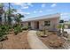 Charming single-story home with a well-maintained yard and inviting walkway to the entrance at 4749 Baywood Point S Dr, Gulfport, FL 33711