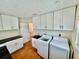 Updated laundry room with modern washer and dryer, stylish cabinets and countertops at 4749 Baywood Point S Dr, Gulfport, FL 33711