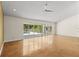 Spacious living room with sleek flooring and sliding glass doors leading to the outdoor pool area at 4749 Baywood Point S Dr, Gulfport, FL 33711