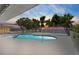 Inviting kidney-shaped pool and spa, surrounded by a white fence and offering spectacular waterfront views at sunset at 4749 Baywood Point S Dr, Gulfport, FL 33711