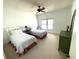 Bright bedroom with twin beds, ceiling fan, and a window providing natural light at 4950 Gulf Blvd # 404, St Pete Beach, FL 33706