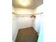 Carpeted closet features built-in shelving and provides ample storage space at 4950 Gulf Blvd # 404, St Pete Beach, FL 33706
