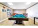 Game room with billiard table, window, seating and bright lighting at 4950 Gulf Blvd # 404, St Pete Beach, FL 33706