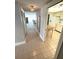 Hallway view leading to kitchen, bright interiors and tile flooring at 4950 Gulf Blvd # 404, St Pete Beach, FL 33706