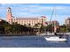 Hotel exterior view with palm trees, landscaping and sailboats docked nearby at 4950 Gulf Blvd # 404, St Pete Beach, FL 33706