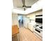 Bright kitchen with white appliances, tile flooring, and breakfast table at 4950 Gulf Blvd # 404, St Pete Beach, FL 33706