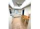 Sunlit kitchen features white cabinets, breakfast bar, and functional layout at 4950 Gulf Blvd # 404, St Pete Beach, FL 33706