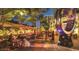 Inviting outdoor dining area with colorful umbrellas and nearby public art at 4950 Gulf Blvd # 404, St Pete Beach, FL 33706