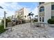 An outdoor kitchen featuring stainless steel grills, a dining table, and a patio area perfect for entertaining at 4950 Gulf Blvd # 404, St Pete Beach, FL 33706