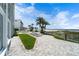 A beautifully paved outdoor pool area with lounge chairs and picturesque beach access at 4950 Gulf Blvd # 404, St Pete Beach, FL 33706