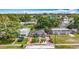 Aerial view of a quaint house showcasing its well-maintained yard, landscaping, and a welcoming orange door at 5005 Tangerine S Ave, Gulfport, FL 33707