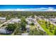 Overhead view of a charming neighborhood with tree-lined streets and a glimpse of the city skyline at 5005 Tangerine S Ave, Gulfport, FL 33707