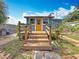 Charming back porch with wooden railing, set amidst a lush backyard at 5005 Tangerine S Ave, Gulfport, FL 33707