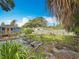 Spacious backyard with a patio, an outdoor dining set, and lush landscaping at 5005 Tangerine S Ave, Gulfport, FL 33707
