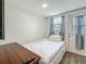 Cozy bedroom with white walls, wood flooring, and natural light from the door and window at 5005 Tangerine S Ave, Gulfport, FL 33707