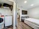 Compact bedroom with laundry machines, wood floors, and convenient access to other rooms at 5005 Tangerine S Ave, Gulfport, FL 33707