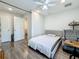 Well-lit bedroom with wood floors, a cozy armchair, and views into an adjacent room at 5005 Tangerine S Ave, Gulfport, FL 33707