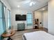 Bright bedroom featuring wood floors, a large window, and an attached desk/bookshelf area at 5005 Tangerine S Ave, Gulfport, FL 33707