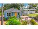 Charming home with a bright orange front door and lush landscaping at 5005 Tangerine S Ave, Gulfport, FL 33707