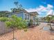 Charming exterior with a brick path, blue siding, and lush landscaping at 5005 Tangerine S Ave, Gulfport, FL 33707